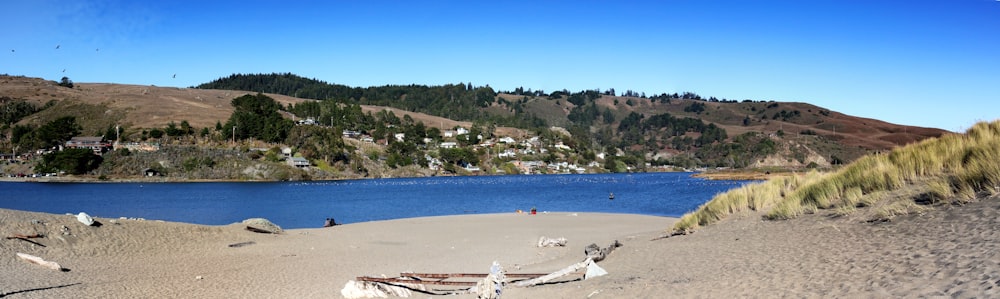 a boat sitting on top of a sandy beach