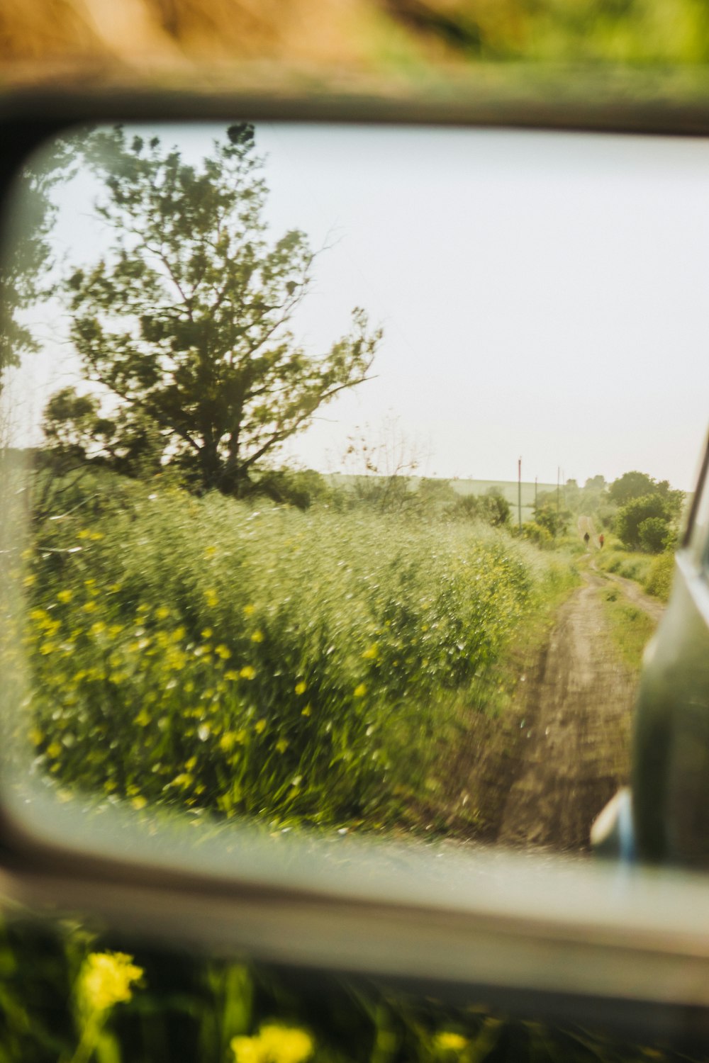 a rear view mirror with a car in the reflection