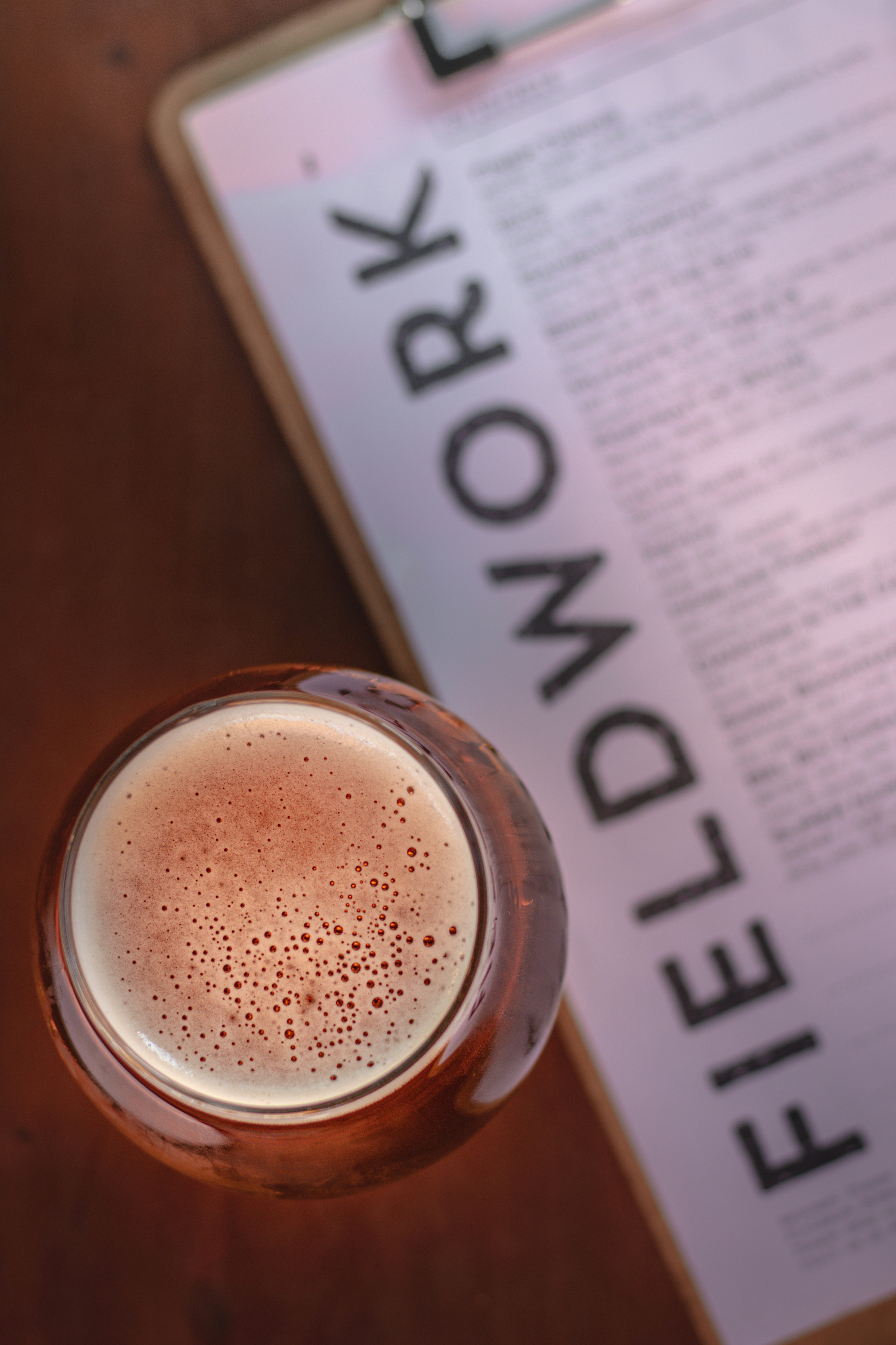a drink sitting on top of a table next to a menu