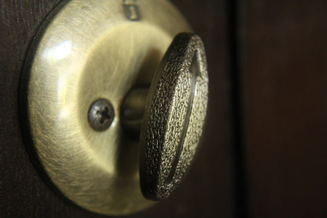 Close-up of a luxury door lock with sleek metallic reflections under warm cinematic lighting.