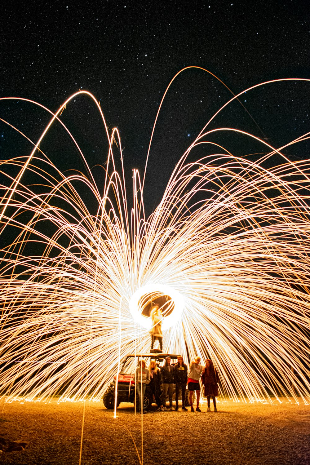 a group of people standing around a firework display