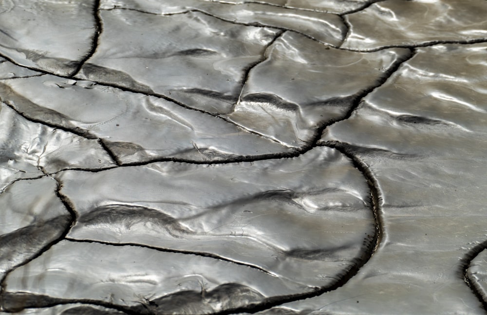 a close up view of a cracked surface of water