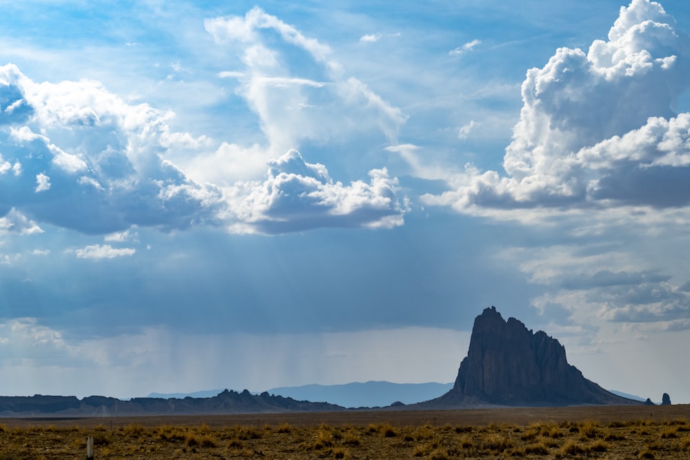 a large rock formation in the middle of a desert