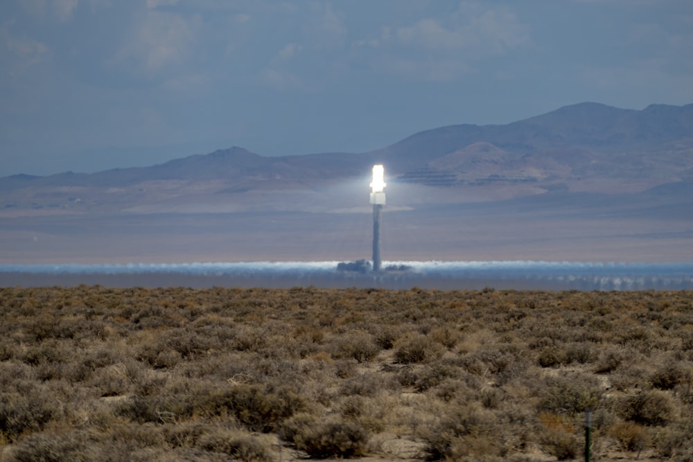 a field with a light tower in the middle of it