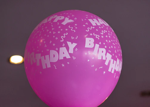 Bright balloon bouquets enhancing a fun birthday party atmosphere.