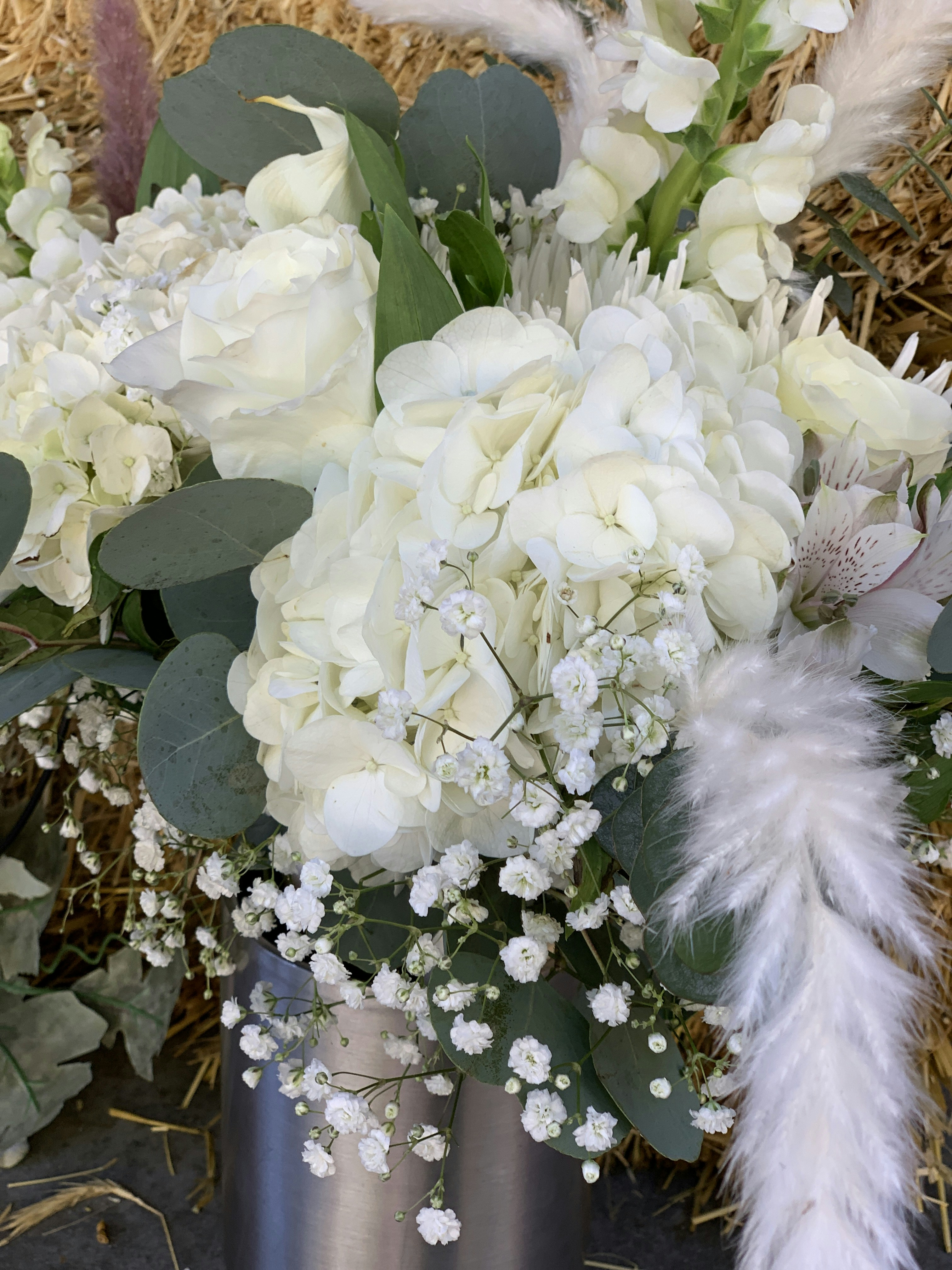 White and cream roses in an elegant moonlit arrangement with silver foliage