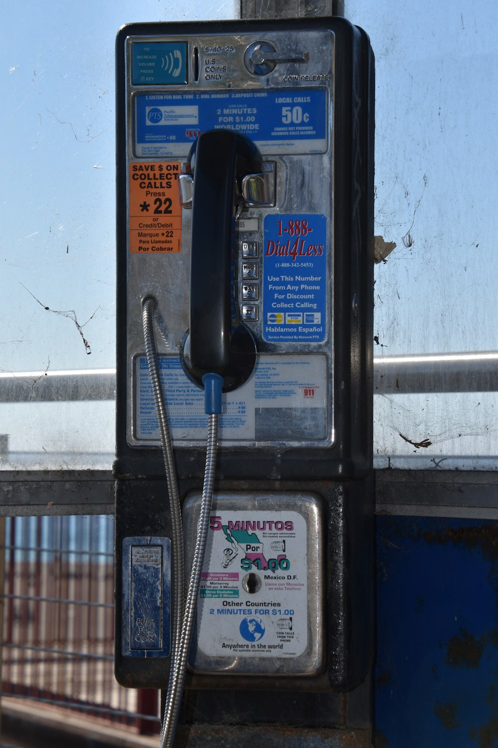 an old fashioned pay phone sitting on the side of a building