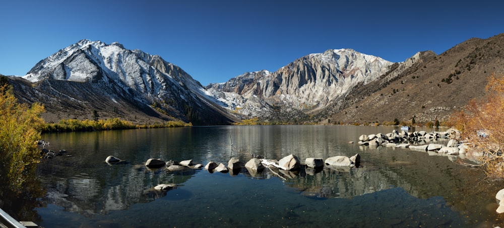 a body of water surrounded by mountains and trees