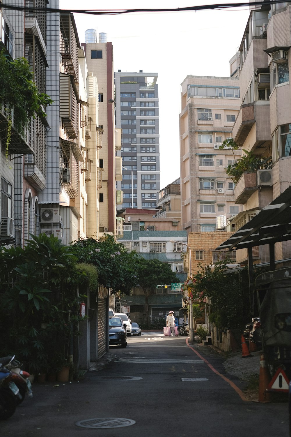 a narrow city street lined with tall buildings