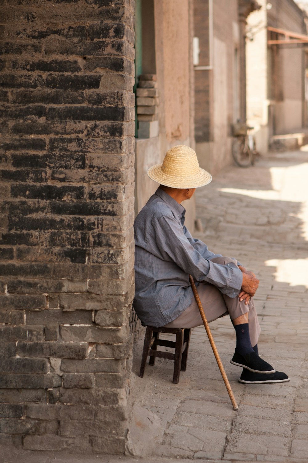 a person sitting on a chair with a cane