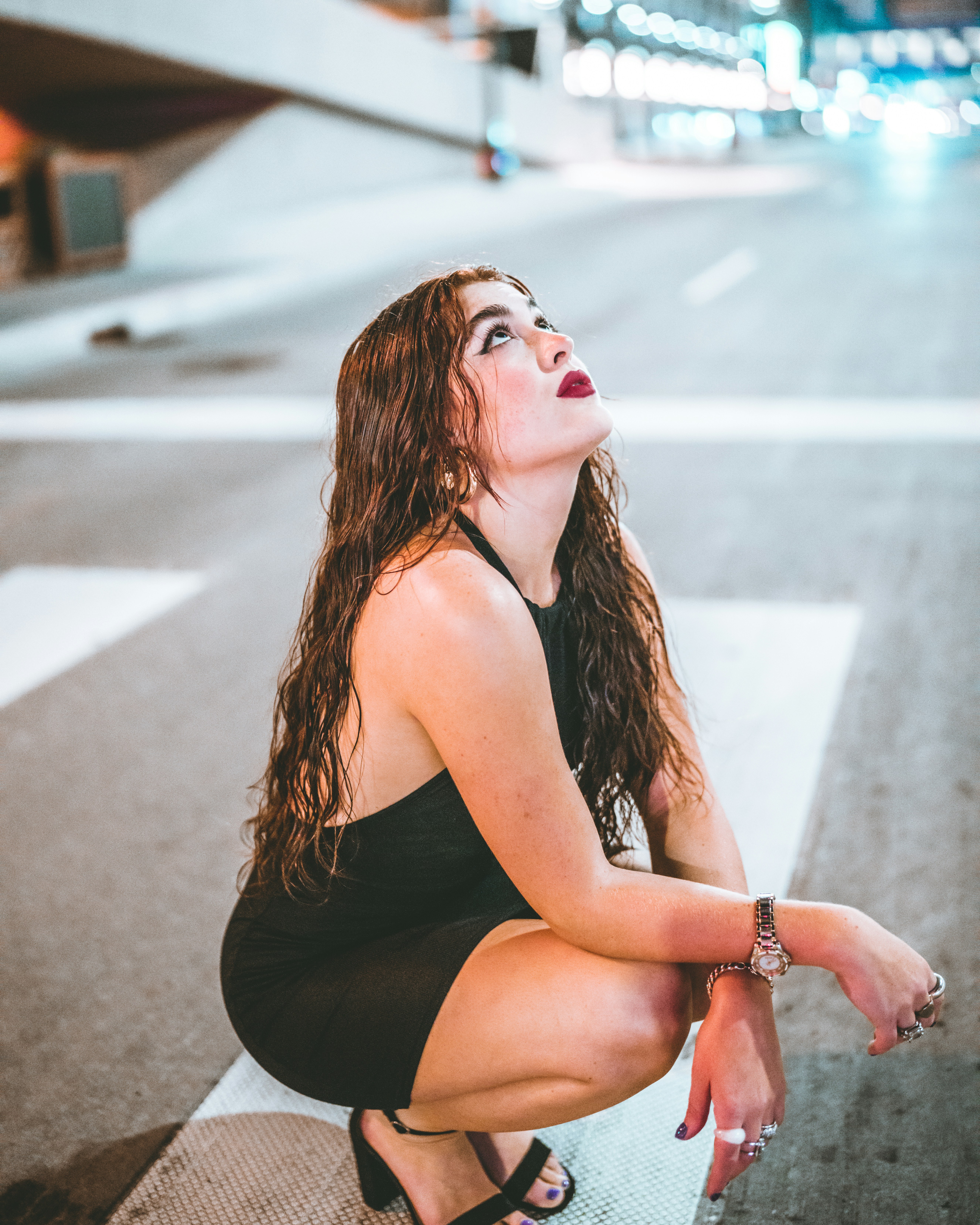 a woman sitting on the side of a road