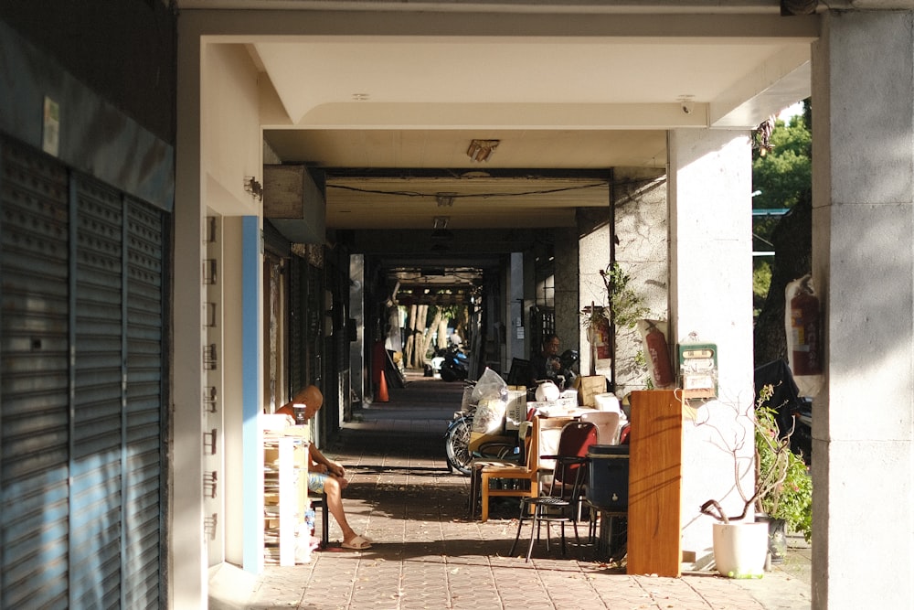 a group of people sitting at a table under an awning