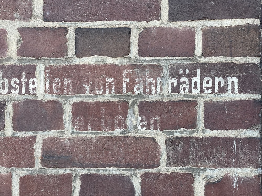 a brick wall with a sign on it