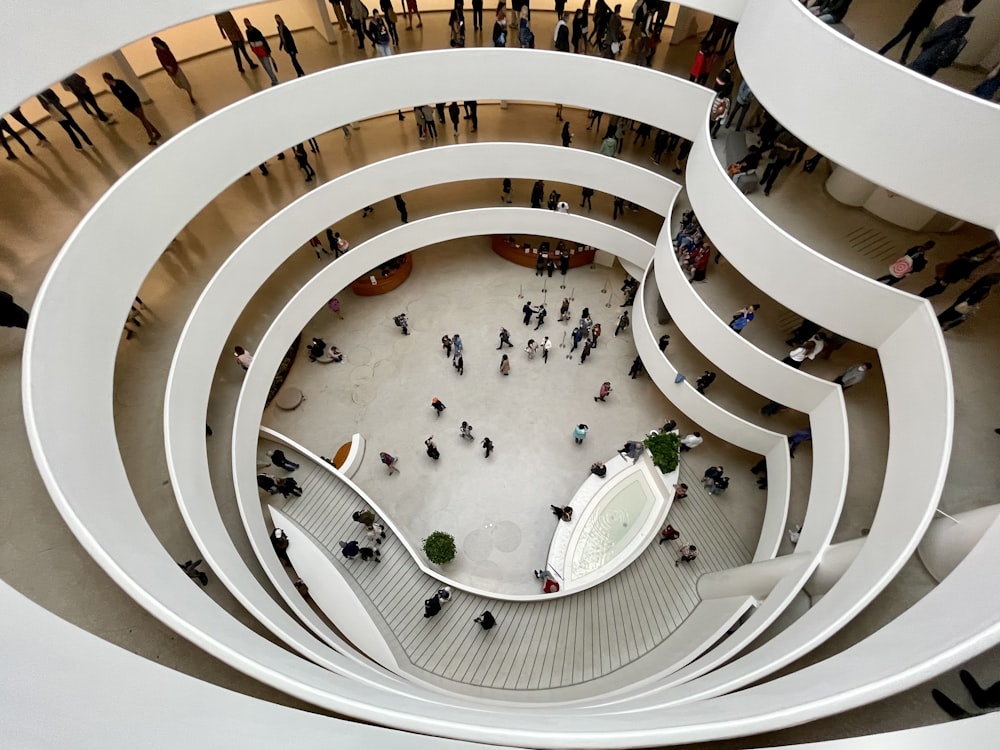 a group of people walking around a building