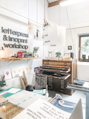 A creative workspace with printing machines and materials organized for efficient production