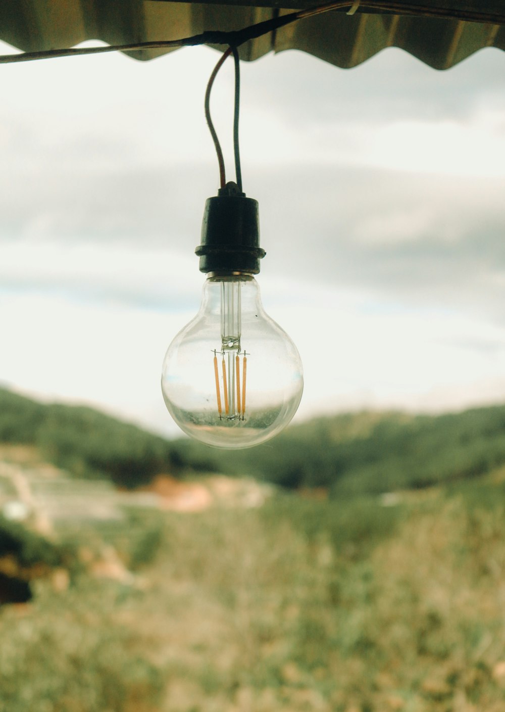 a light bulb hanging from the side of a roof