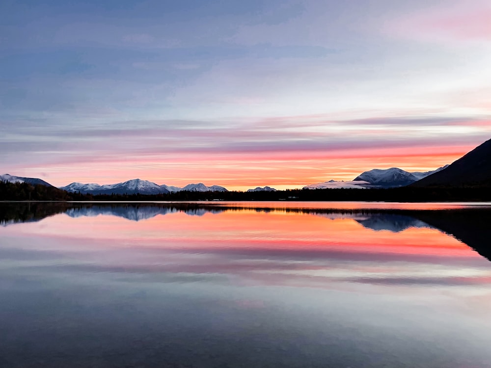 a lake with a mountain range in the background