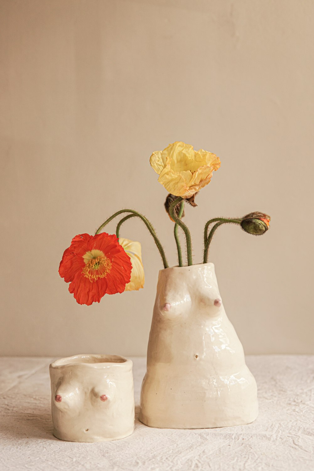 a couple of vases that have flowers in them