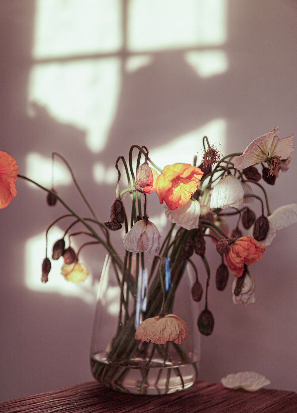 a vase filled with flowers on top of a wooden table