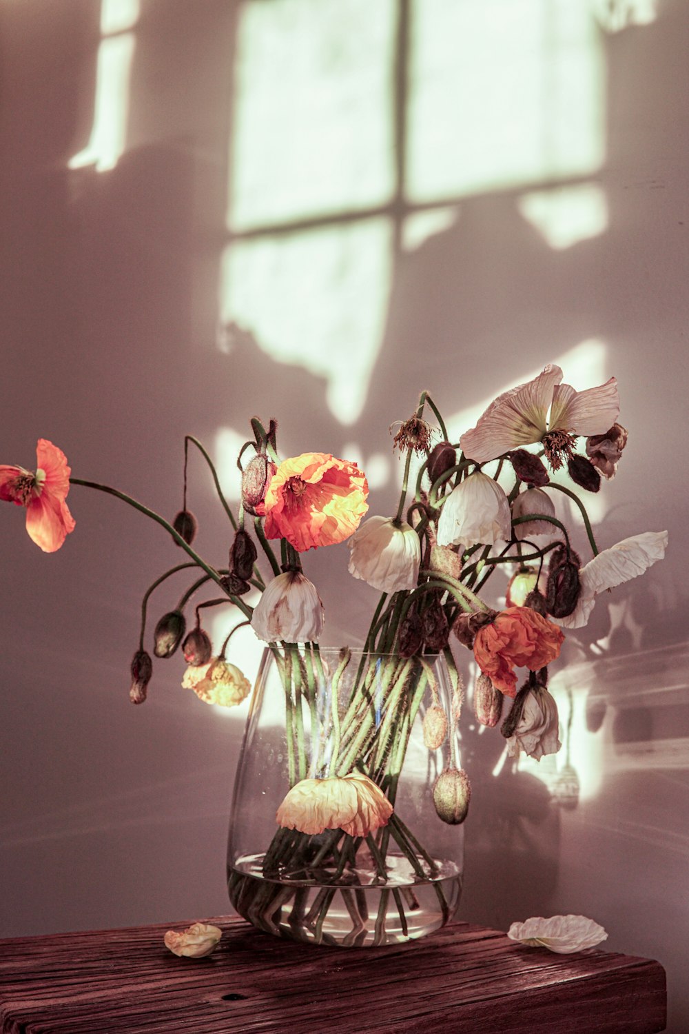 a vase filled with flowers on top of a wooden table