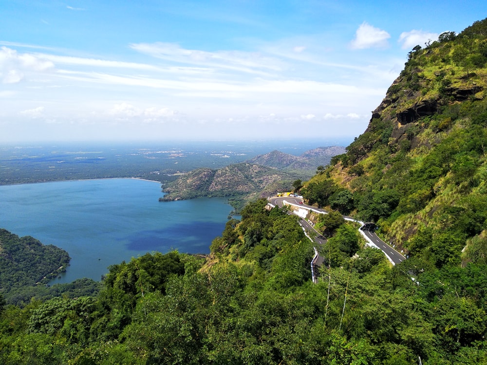 a scenic view of a mountain with a lake in the distance