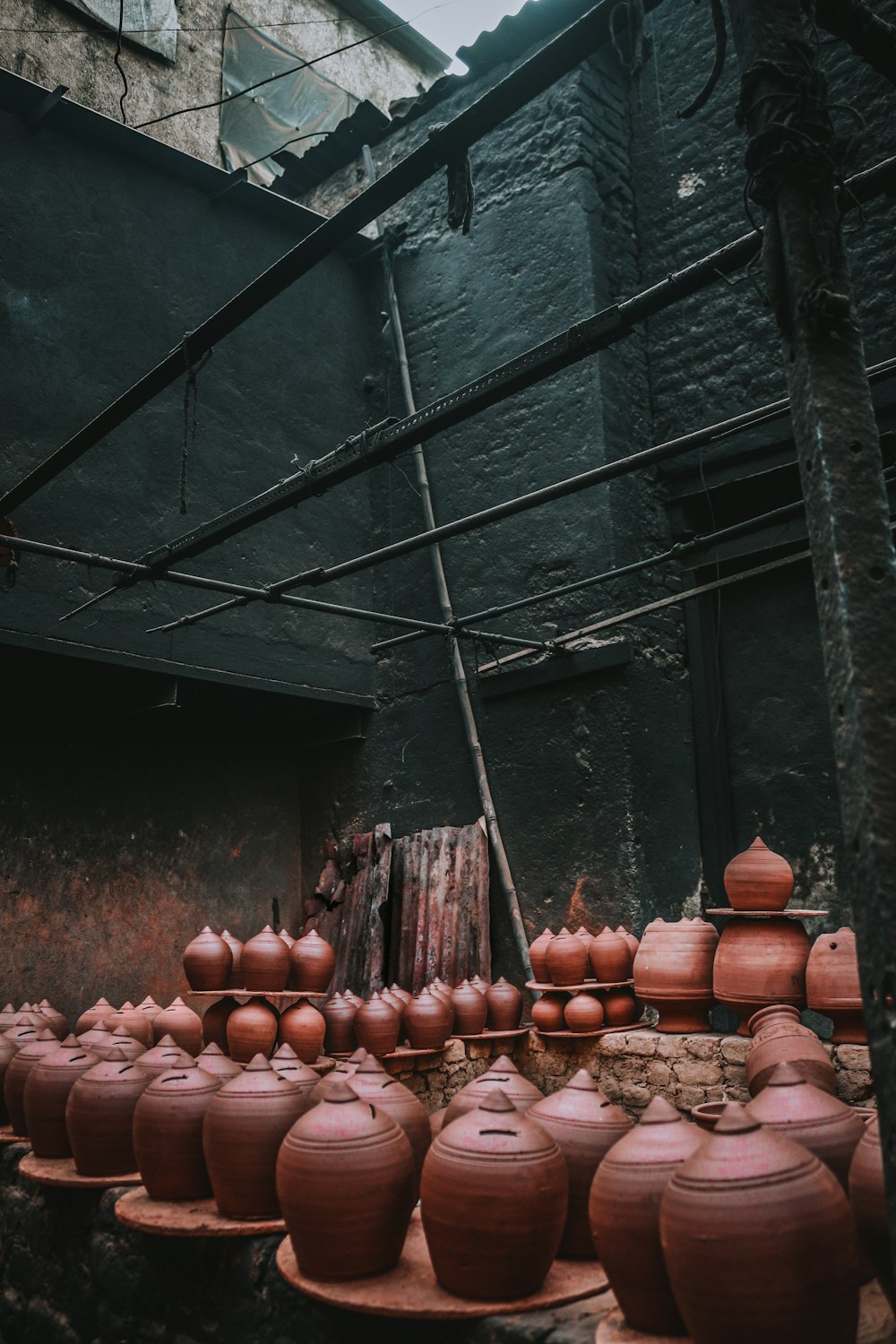 a group of clay pots sitting on top of a wooden table