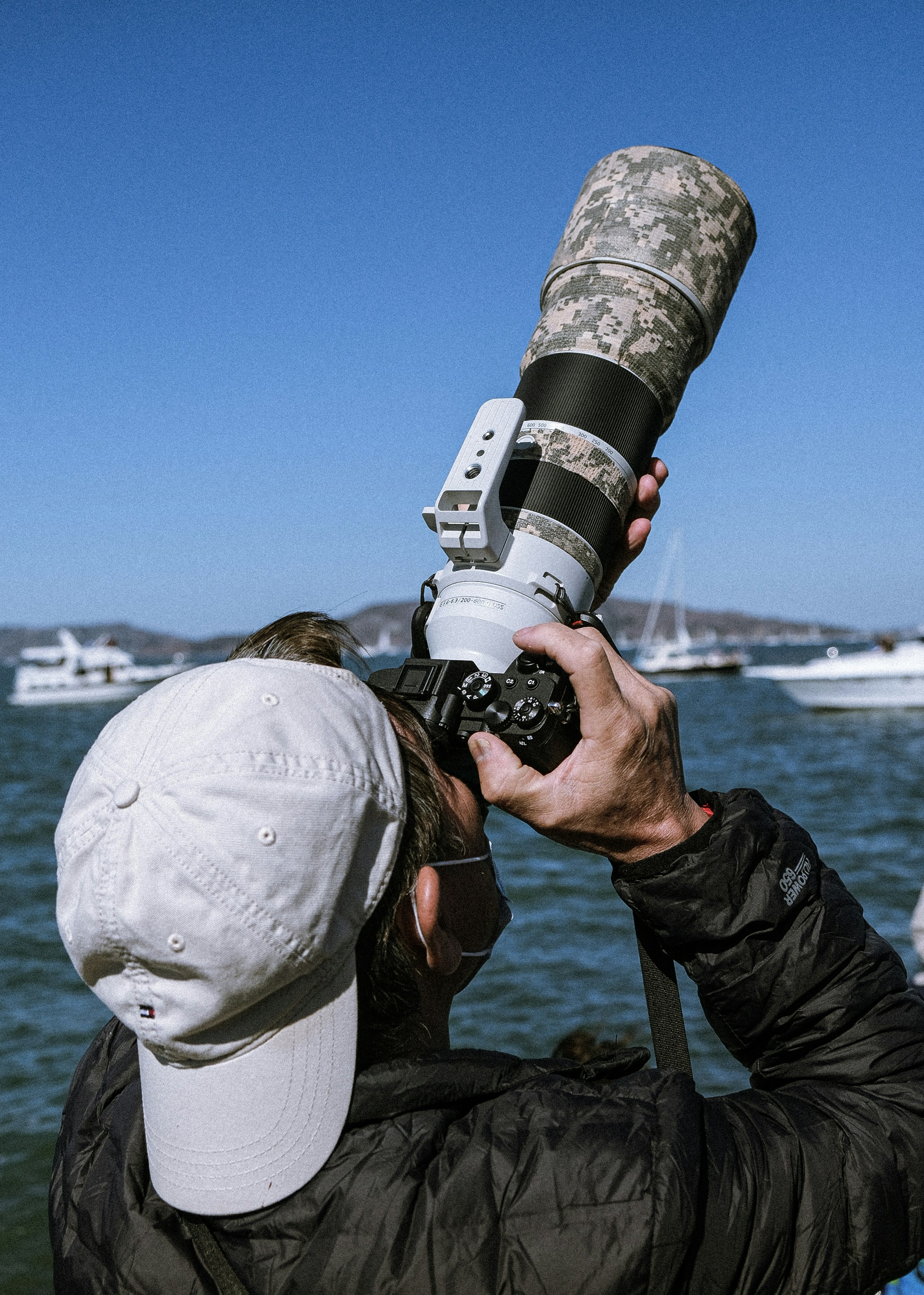 a man taking a picture of a body of water with a camera