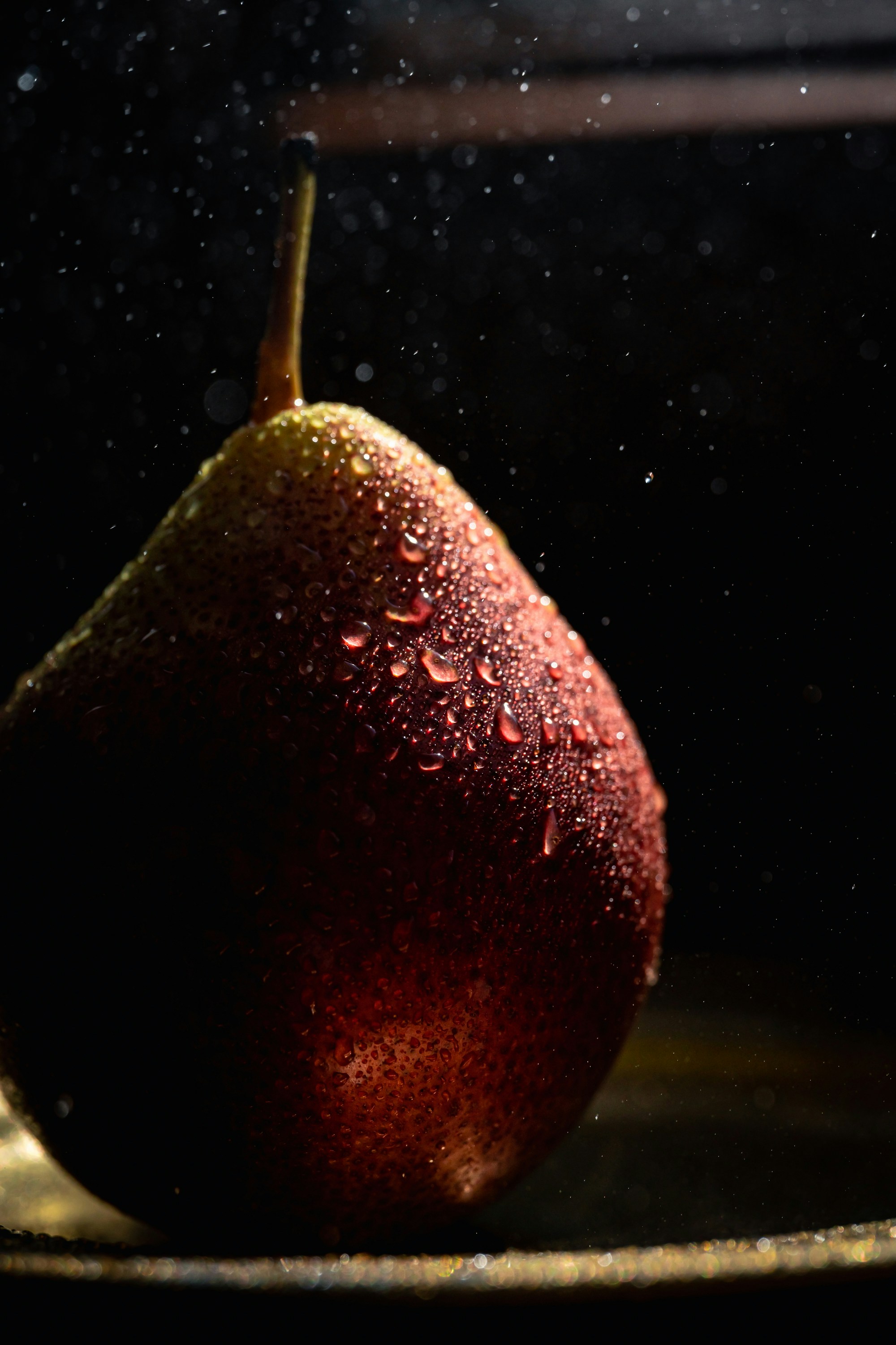 a close up of a pear on a plate