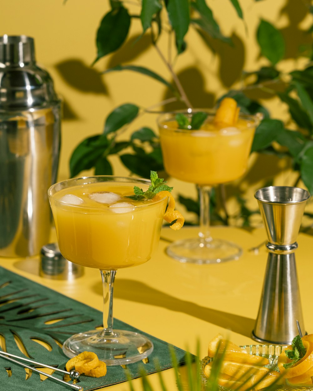 a table topped with two glasses filled with drinks