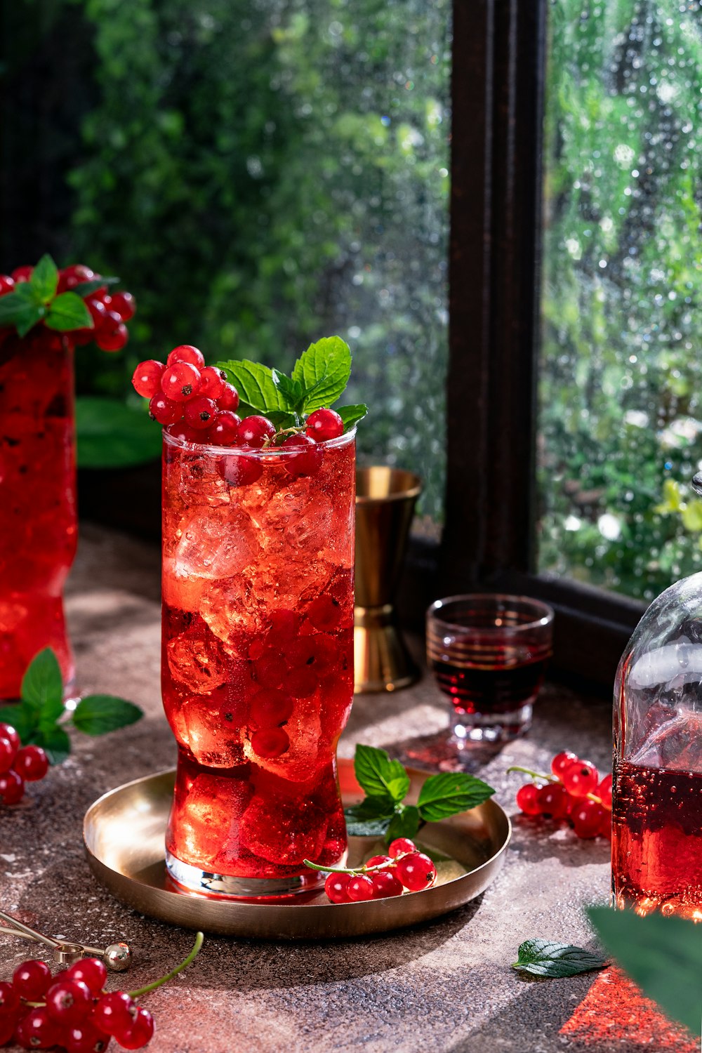 a glass of red wine with ice and berries