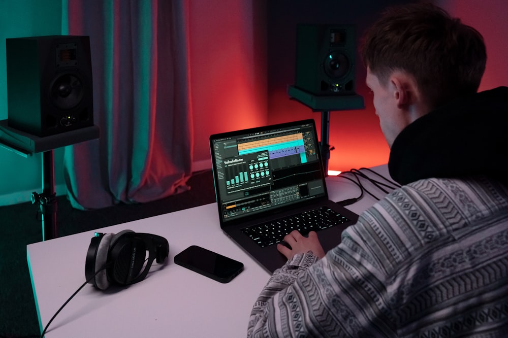 a man sitting in front of a laptop computer