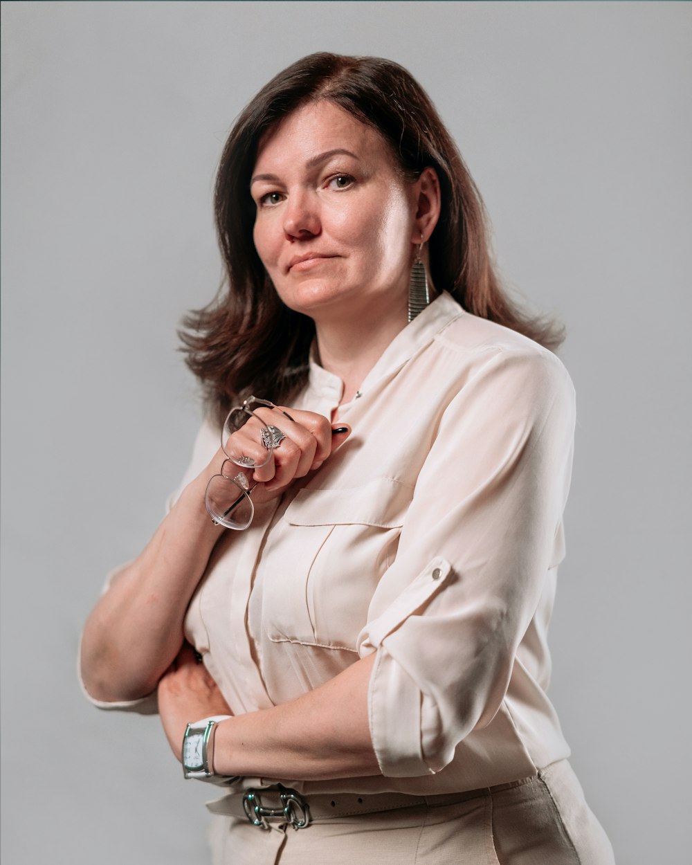 a woman in a white shirt is posing for a picture