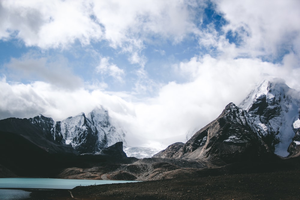 a mountain range with a body of water in the foreground