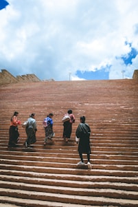 a group of people walking up some steps