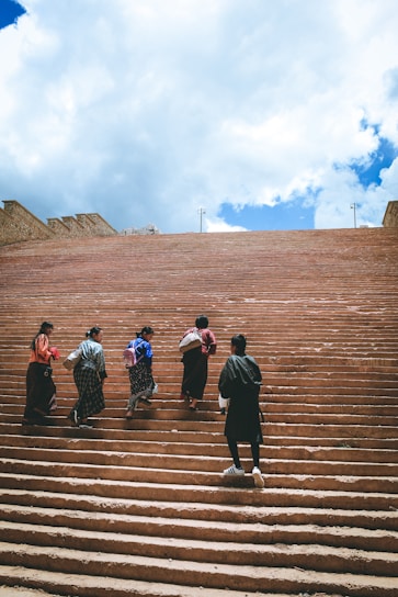a group of people walking up some steps