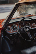 a car dashboard with a steering wheel and gauges
