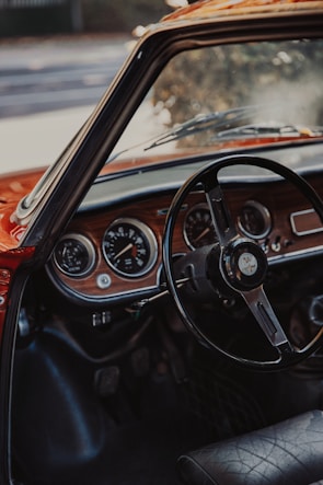 a car dashboard with a steering wheel and gauges