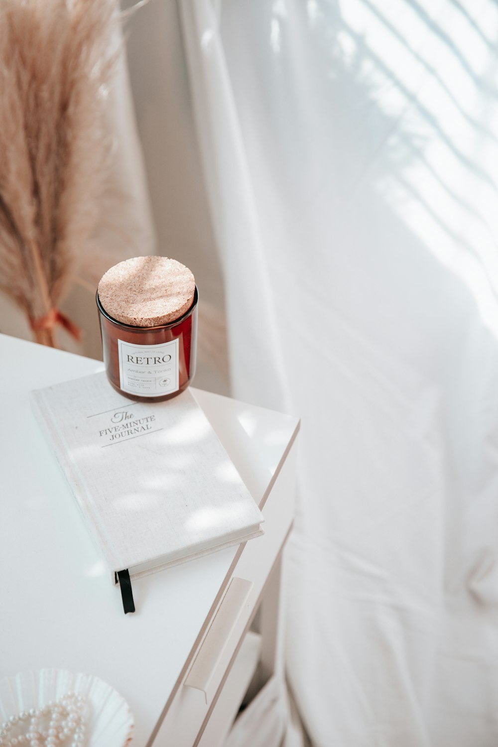 a candle on top of a book on a table