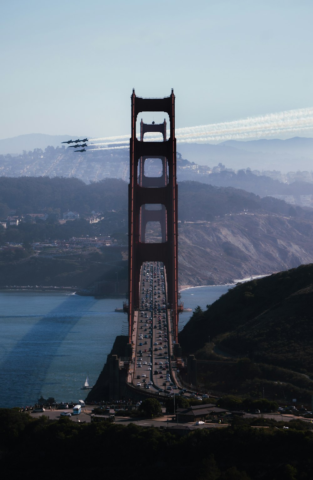 a plane flying over the top of a bridge