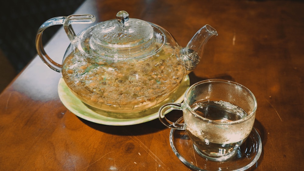 a tea pot and a glass cup on a table