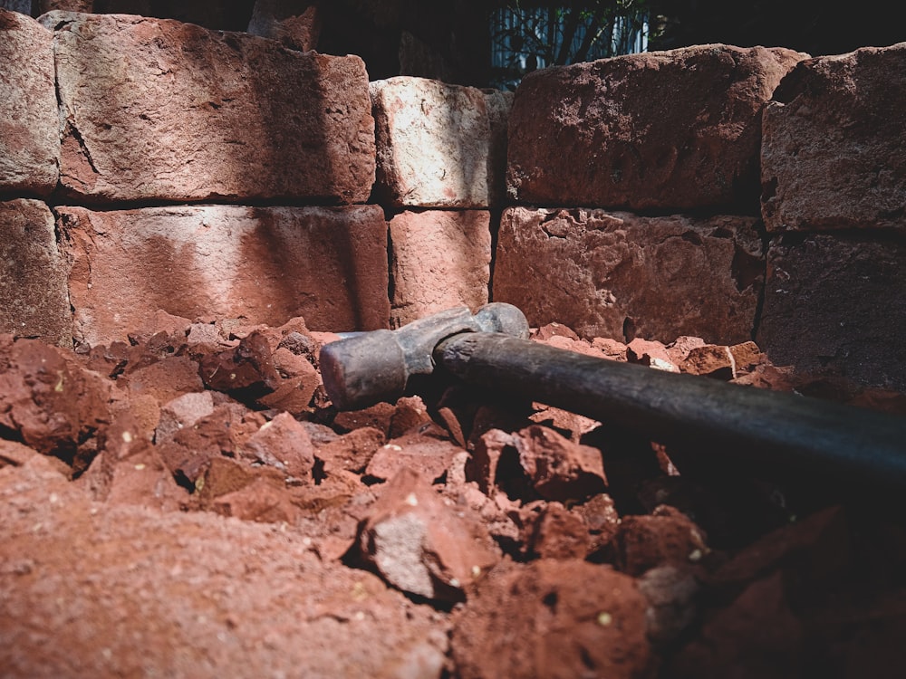 a pipe laying on top of a pile of rocks