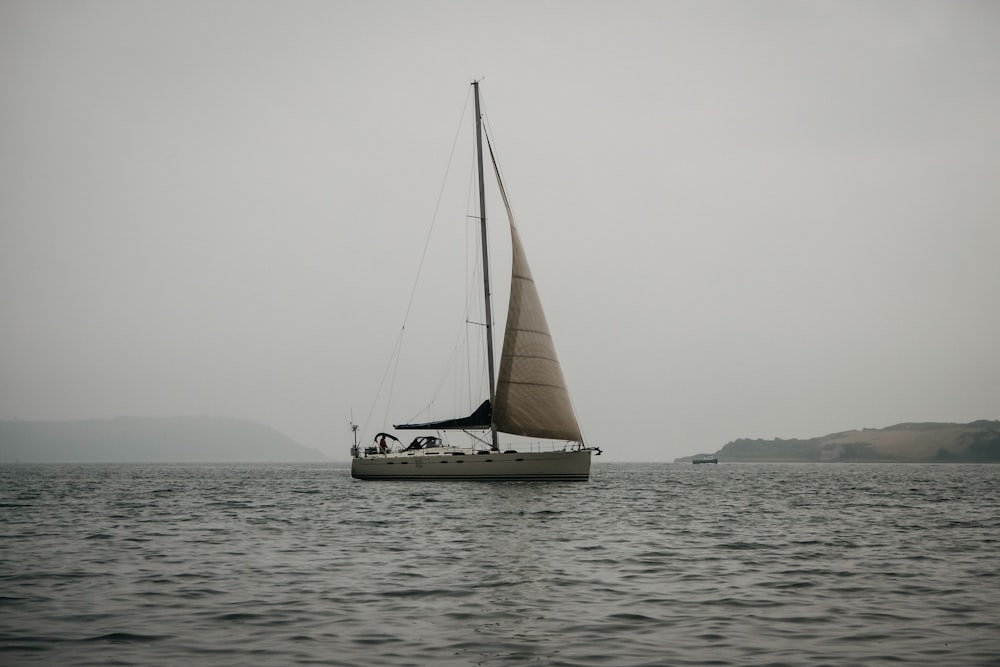 a sailboat floating on top of a body of water