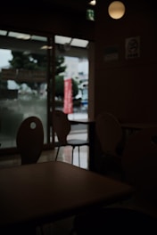 A restaurant owner looking at an empty dining room with a worried expression.