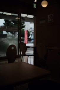 A restaurant owner looking at an empty dining room with a worried expression.