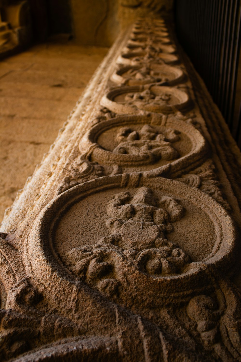 a long line of stone carvings on the side of a building