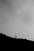 Close-up of determined faces, sweat and grit visible, as runners push through a steep hill.