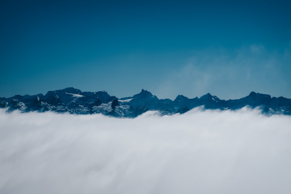 a view of a mountain range from above the clouds