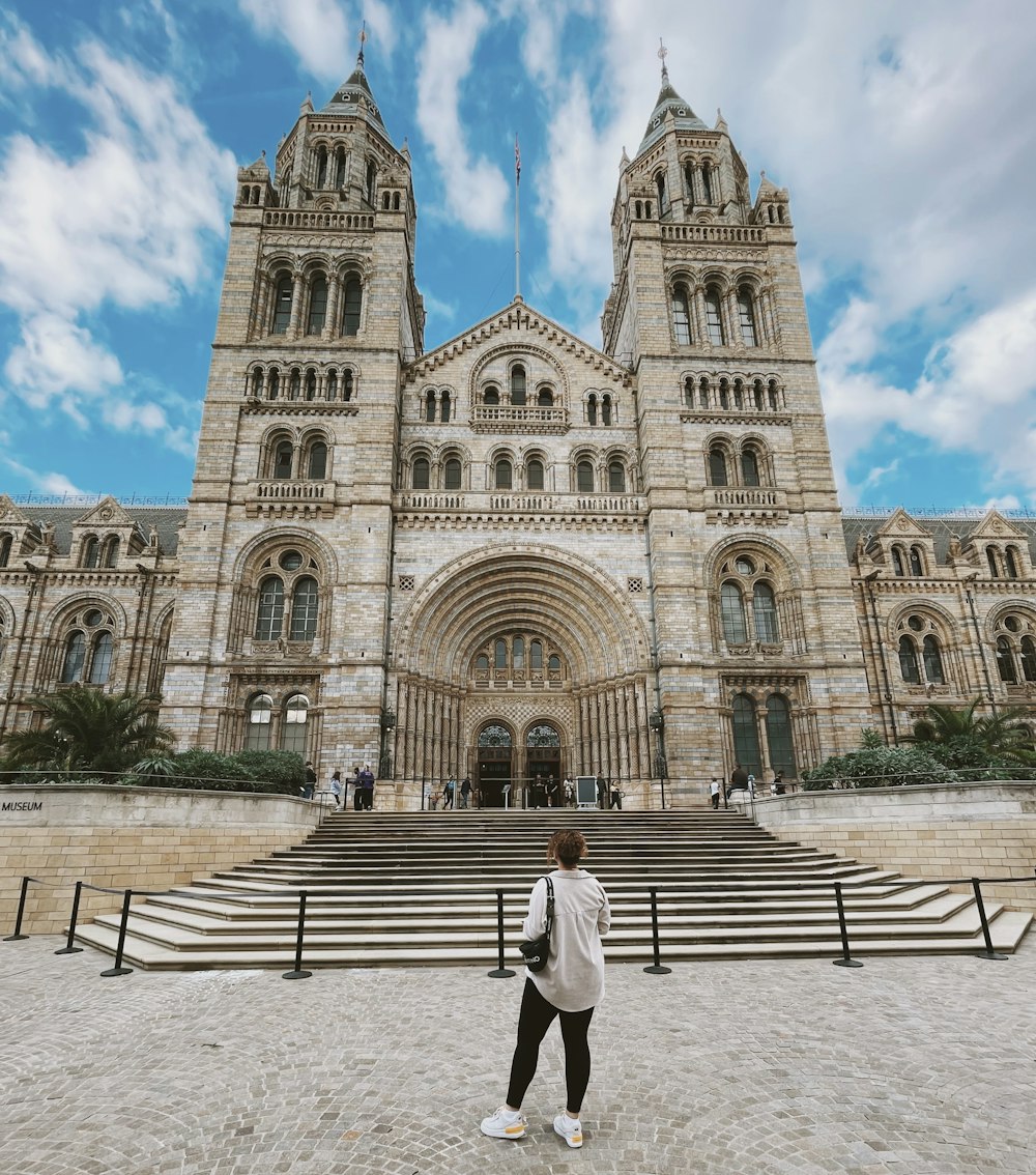 a person standing in front of a large building