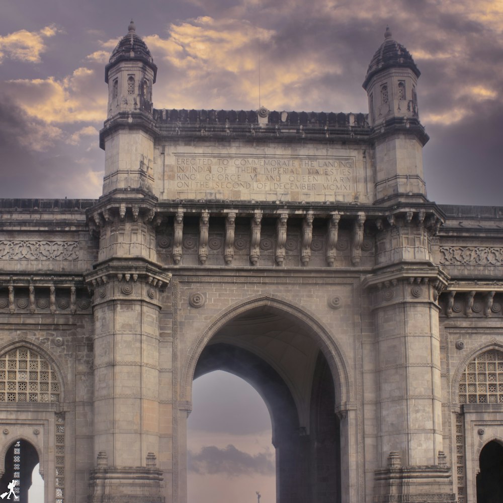 a large stone arch with a clock on it