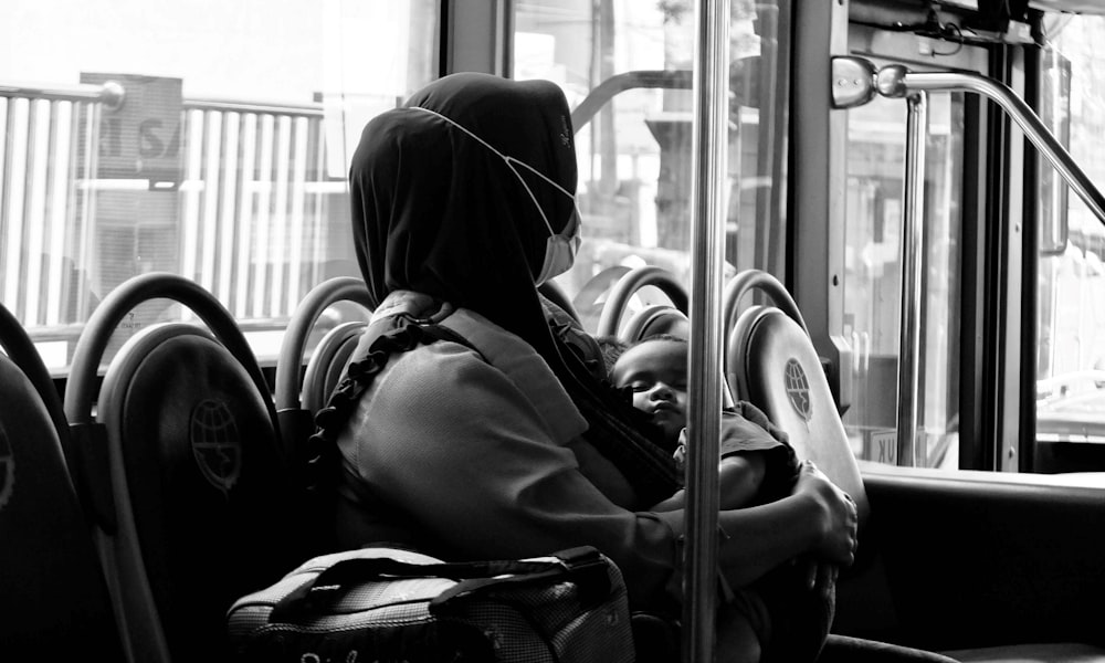 a woman sitting on a bus looking out the window